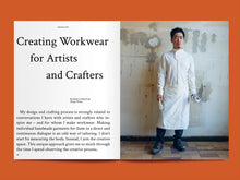 Load image into Gallery viewer, Magazine spread features article titled: "Creating Workwear for Artists and Crafters", alongside photo of man wearing a wrap collared shirt and apron
