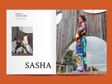 Load image into Gallery viewer, Magazine spread features the title: "Sasha", alongside photo of lady wearing a busy patterned jumpsuit