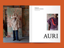 Load image into Gallery viewer, Magazine spread features photo of lady wearing a collarless overshirt jacket, and statement puff hat, alongside title: "Auri".