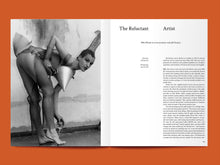 Load image into Gallery viewer, Magazine spread features photo of lady bending over, wearing a mesh outfit holding a metal cone, alongside article titled: "The Reluctant Artist".