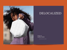 Load image into Gallery viewer, Magazine spread features photo of lady holding up a hexagonal block bag, alongside title: "Delocalized".