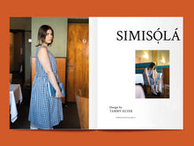 Load image into Gallery viewer, Magazine spread features photo of lady wearing a gingham sleeveless dress, alongside the title: "Simisólá".
