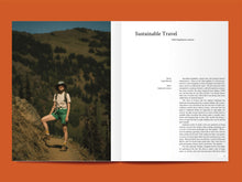 Load image into Gallery viewer, Magazine spread features photo of lady summer hiking, alongside article titled: "Sustainable Travel".