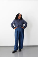 Load image into Gallery viewer, Lady stands in front of wall wears a buttoned up stripe shirt with elasticated waist trousers