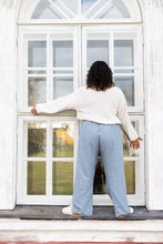Load image into Gallery viewer, Person stands on window ledge wearing jumper and checkered elasticated waist trousers
