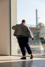 Load image into Gallery viewer, Back view of model wearing short jacket with an inverted pleated at yoke
