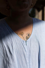Load image into Gallery viewer, Close up of neckline, model wearing a curved V neckline, fastened at centre-front with a concealed zip