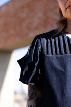 Load image into Gallery viewer, Close up of shoulder, model wears a denim top with pleated detailing at shoulder, and sleeve cap