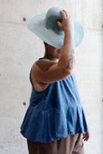 Load image into Gallery viewer, Model wears a sleeveless denim top, with peplum detail