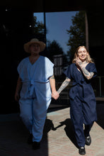 Load image into Gallery viewer, Two models wear V-neck jumpsuits, holding hands