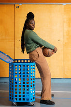 Load image into Gallery viewer, Lady holds a basketball leaning on a box trolley cage of balls. Wears trousers and long sleeve top made of jersey