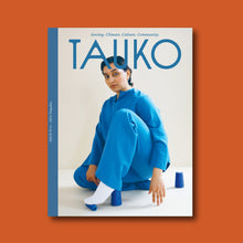 Load image into Gallery viewer, TAUKO magazine front cover. Lady sat on floor in all one colour outfit
