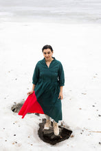 Load image into Gallery viewer, Lady stands in amidst snow, wearing a dress with elasticated waist, and contrasting colour panel