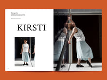 Load image into Gallery viewer, Two page spread; left side features model wearing a sleeveless button-up bodice with cross-over pleated skirt, below text that reads "Kirsti". Right side is image of model leaning back towards the wall in pose, wearing sleeveless bodice, and mid-shin length skirt