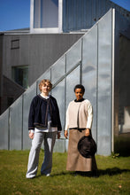 Load image into Gallery viewer, Two models standing outdoors in front of a modern building, wearing short, collarless jackets