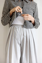 Load image into Gallery viewer, Model wears pleated waist detail trousers, at elasticated waist