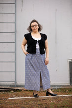 Load image into Gallery viewer, Lady wears a long straight skirt with slit at centre front from hem