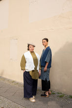 Load image into Gallery viewer, Two ladies stand by wall wearing long, elbow length sleeve shirts with a waistcoat jacket over the top.