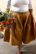 Load image into Gallery viewer, Lady wears wide legged culottes, pleated at the waistband