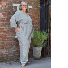 Load image into Gallery viewer, Model wears a jumpsuit with tie belt at waist, hands in pockets