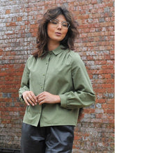 Load image into Gallery viewer, Model wears a long-sleeve, collared blouse with pleats at shoulder seams