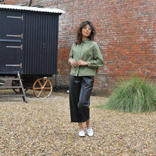 Load image into Gallery viewer, Model wears a long-sleeve, collared blouse with pleats at shoulder seams