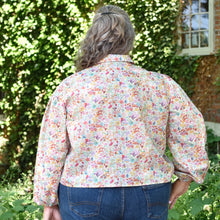 Load image into Gallery viewer, Back view of model wearing a collared blouse with long sleeves, gathered into a cuff