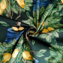 Load image into Gallery viewer, Cotton Lawn fabric with a pattern of lemon trees, displayed with central swirl