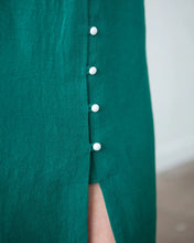 Load image into Gallery viewer, Close up of model wearing button front dress, shows the bottom of the buttons, with loop fastenings