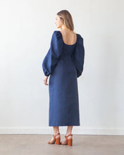 Load image into Gallery viewer, Back view of model wearing long dress with low back scoop neckline, and long puff sleeves
