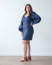 Load image into Gallery viewer, Model wears button-front, above knee-length dress, with long puff sleeves