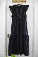 Load image into Gallery viewer, V-neck dress with flutter shoulder detail, and tiered gathered skirt, with waist tie, displayed on hanger