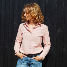 Load image into Gallery viewer, Lady wears the Anna Shirt tucked into jeans. Button up front, fastened to the chest, long sleeves with cuff. Smart wear.
