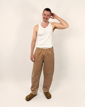 Load image into Gallery viewer, Front view of model wearing elasticated waist trousers with curved legs