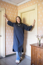 Load image into Gallery viewer, Lady wears a sweater dress with curved hem over denim jeans