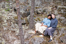 Load image into Gallery viewer, two ladies sat closely on rocks, both wearing puffy sleeved, polo neck tops, with wide legged cropped trousers