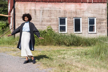 Load image into Gallery viewer, Lady wears a pin tuck front shirt tucked into skirt, and a long open jacket