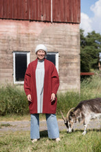 Load image into Gallery viewer, Lady stands by sheep wearing a long open jacket