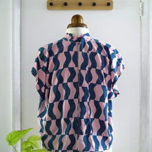 Load image into Gallery viewer, Back view of zero waste tie top on mannequin; a sleeveless blouse with tie neck