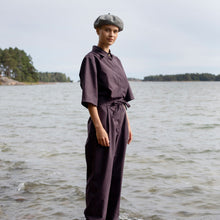 Load image into Gallery viewer, Lady wears an elbow length shirt and trouser jumpsuit with beret hat, stood by a lake