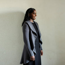 Load image into Gallery viewer, Lady wears a jacket with fluted edging from collar down the sides