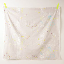 Load image into Gallery viewer, Square piece of Organic Cotton Double Gauze fabric hangs on a wall by two pieces of tape at the top two corners, displays a floral print