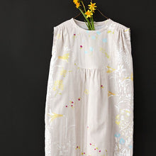 Load image into Gallery viewer, Child's sleeveless dress made using the PAL Organic Cotton Double Gauze fabric, hung on hanger with flowers
