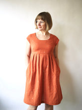 Load image into Gallery viewer, Lady wears Trillum Dress, with pleats at waistline.