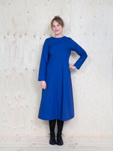 Load image into Gallery viewer, Lady stands wearing midi dress with straight long sleeves