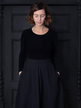 Load image into Gallery viewer, Lady stands with hands in pockets of tulip shaped skirt