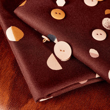 Load image into Gallery viewer, Folded fabric pieces of EcoVero Viscose Twill laid with buttons