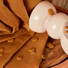 Load image into Gallery viewer, Linen viscose fabric in pleated folds with scattered buttons amongst a vase lays atop the fabric