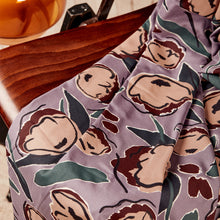 Load image into Gallery viewer, EcoVero Viscose fabric with large floral print, in soft pleated folds lain on chair