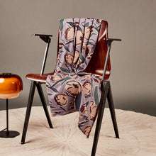 Load image into Gallery viewer, EcoVero Viscose fabric with large floral print, draped over wooden chair next to a floor lamp